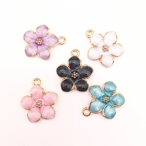 Detailed view of colorful enamel cherry blossom charms in purple, white, and pink