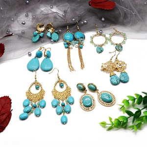 Detailed collection of bohemian turquoise drop earrings with gold accents and tassels