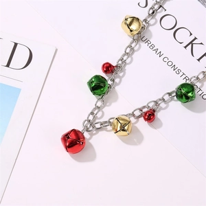 Detailed view of silver Christmas bracelet featuring festive red, green, and gold bells