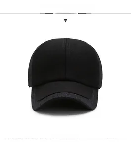 Detail of black winter wool baseball cap with silver metal Sport emblem for men