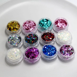 Colorful cosmetic glitter flake set in small jars, perfect for festival makeup and party looks.