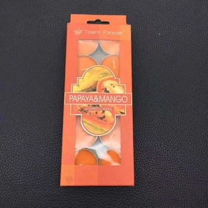 Détail du coffret de bougies parfumées papaye et mangue avec chauffe-plats orange