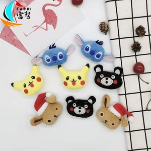 Flat lay of cute plush cartoon character patches with detailed embroidery for accessories