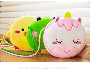 Detailed close-up of colorful cartoon plush crossbody bags for children on wood