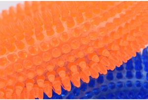 Macro view of durable TPR dog toy showing spikes for dental cleaning and gum massage