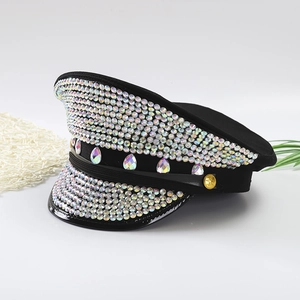 Sparkly rhinestone captain hat with emerald gems and gold star detail on white base