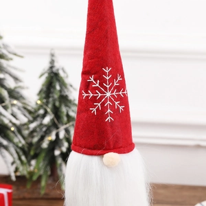 Nordic Christmas gnome bottle cover with red felt hat and white snowflake embroidery