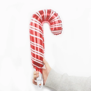 Detail of candy cane shaped foil balloon with red and white festive stripes