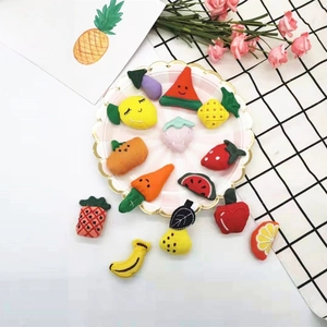 Detailed close-up of cute plush fruit and vegetable charms for accessories and crafts