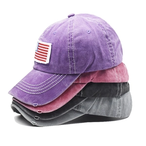 Close-up of distressed cotton baseball caps in multiple colors with American flag embroidery