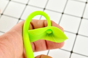 Close-up of flexible green silicone lucky clover leaf gel pen showing material elasticity
