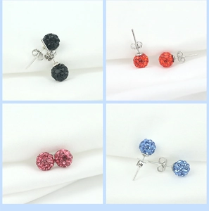 Macro detail of round disco ball stud earrings in black, red, pink, and blue crystal