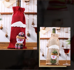 Detail of burlap Christmas wine bottle bags with 3D snowman dolls and drawstring closure