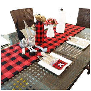 Christmas table runner set with red plaid decor, wine covers, and gnome ornaments