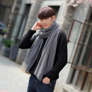 Men's grey knitted winter scarf in soft cashmere-like fabric on outdoor model