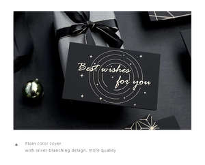 Detail of elegant black gift card with gold foil Best Wishes text and ribbon decor
