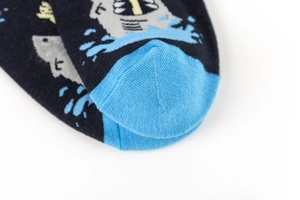 Macro shot of cotton shark socks featuring a reinforced light blue toe and navy blue fabric
