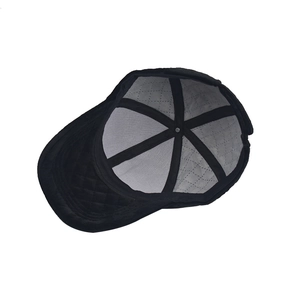 Detail view of the reinforced inner grey lining and quilted brim of a black baseball cap