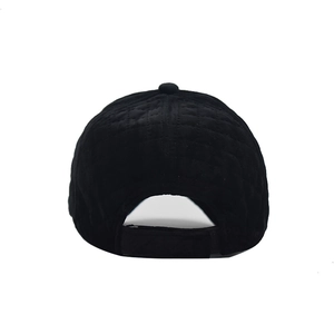 Rear view of black quilted corduroy baseball cap with adjustable strap and grid texture