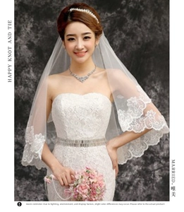 Detail of white 3m single layer bridal veil featuring exquisite scalloped lace floral edges