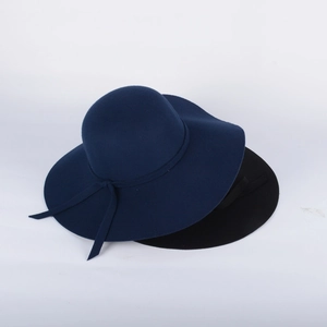 Detailed view of navy blue and black wide brim wool felt hats with elegant wavy edges