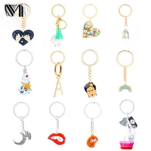 Detail view of 12 vintage Y2K guitar star keychains with enamel and metallic charms