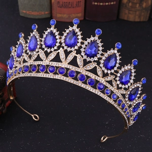 Macro detail of royal baroque crown with deep blue crystals and gold alloy base