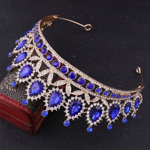 Close-up of golden baroque tiara with blue water-drop crystals and rhinestones