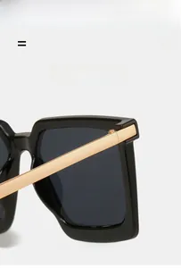 Detail of premium square sunglasses featuring gold metal temples and high-quality hinges