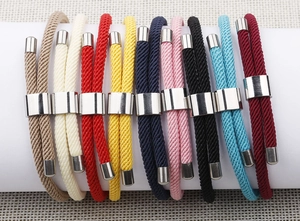Macro shot of colorful braided Milanese cords with metallic anchor charms for bracelets