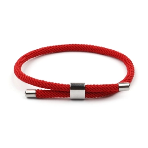 Detail of red braided rope bracelet with adjustable silver titanium steel clasp on white background