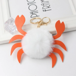 Portachiavi a forma di granchio in peluche con pon pon bianco e zampe in ecopelle
