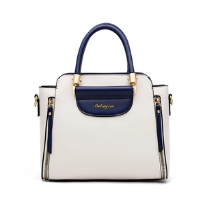 Women's minimalist color-block handbag in cream and navy blue with gold accents