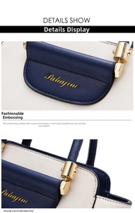 Close-up of blue and white contrast leather handbag with golden logo and metallic hardware