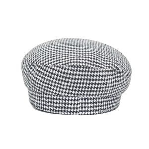 Detail of classic black and white houndstooth wool fabric on a vintage newsboy cap