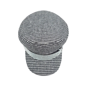 Detailed texture of black and white houndstooth baker boy hat with sparkling silver rhinestones