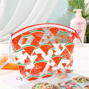 Close-up of semi-circle transparent PVC makeup bag with red watermelon print and red zipper