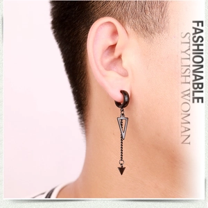 Close-up of a matte black punk triangle earring with long chain pendant on ear