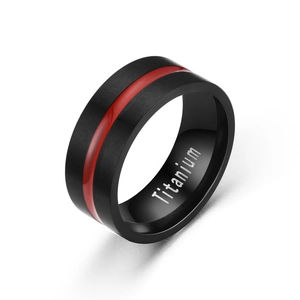Macro detail of men's titanium steel ring with black brushed finish and red center line