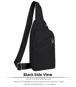 Detail of black crossbody chest bag featuring a functional headphone port and metal zippers