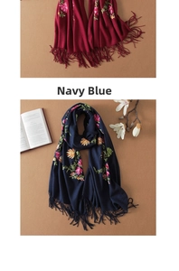 Close-up of intricate floral embroidery on red and navy wool pashmina scarves