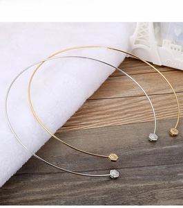 Detail of elegant hexagonal choker necklace in gold and silver finish with pavé crystals