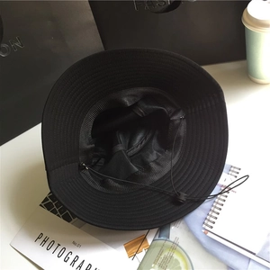Minimalist black wide brim sun hat with adjustable chin strap and breathable mesh lining