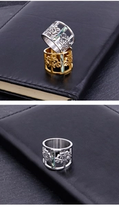 Detailed close-up of hollow Tree of Life rings in gold and silver with pearl inlay