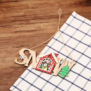 Rustic wooden SNOW hanging sign with Christmas tree and red house on dark wood