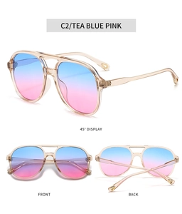 Detail view of oval double bridge sunglasses with tea blue pink gradient lenses and PC frame