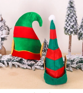 Detail view of red and green striped Christmas elf hats on a snowy holiday background