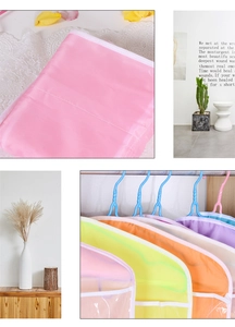 Macro view of multi-color PEVA shoulder dust covers for closet clothes organization