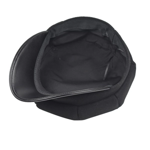 Detail view of the black newsboy hat's inner lining and reinforced leather brim binding