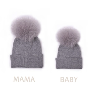 Gray knitted parent-child beanie set with large fluffy pom-poms for mama and baby